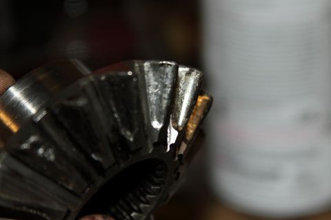 2004 Jeep TJ - This differential spider gear shows significant damage to its teeth, indicating a mechanical failure.