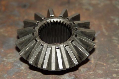 2004 Jeep TJ - A close-up view of a differential spider gear, showing signs of wear on its teeth and internal splines.