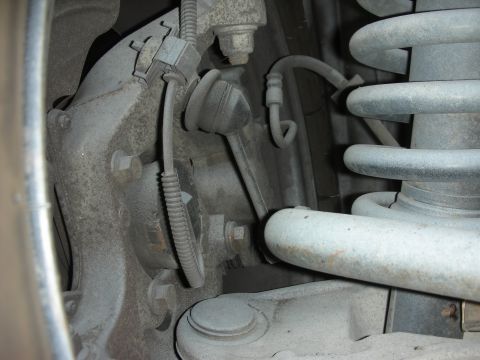 2004 Ford Crown Victoria - Detail of a vehicle's suspension system, showing various mechanical components and wiring.