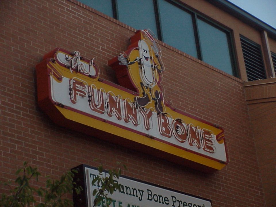 Funny Bone neon sign with hot dog mascot