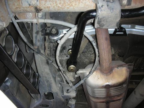 2004 Ford Crown Victoria - Aftermarket rear sway bar installation in progress, focusing on the suspension and exhaust system.