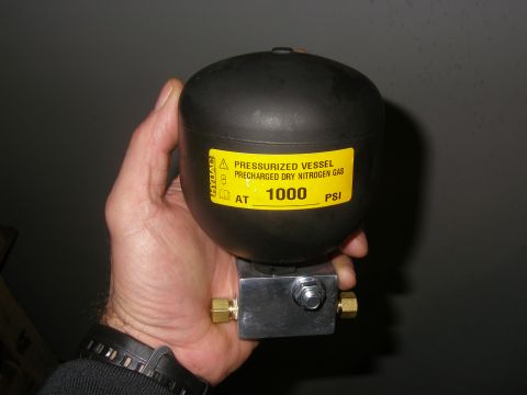 1990 Ford Bronco - A pressurized vessel for dry nitrogen gas, precharged to 1000 PSI, is held in a person's hand.