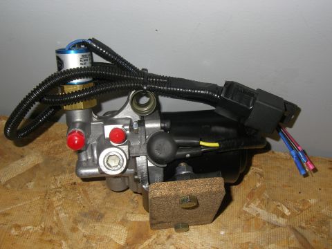 1990 Ford Bronco - An ABS electric boost brake actuator is shown mounted on a wooden surface.