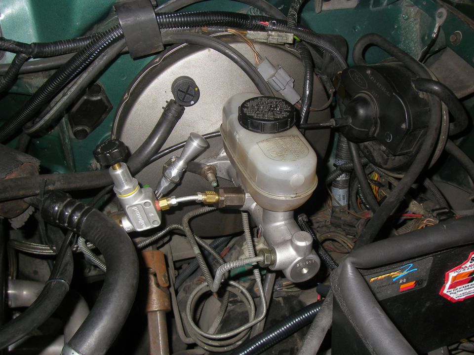 Brake booster and master cylinder assembly with associated lines and hoses