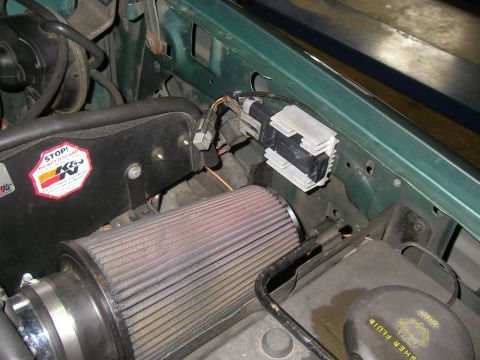 1990 Ford Bronco - Close-up of an engine bay a K&N air filter and an ignition control module.