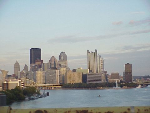 1998 Ford Taurus - The Pittsburgh skyline is visible across the water, numerous buildings and bridges.
