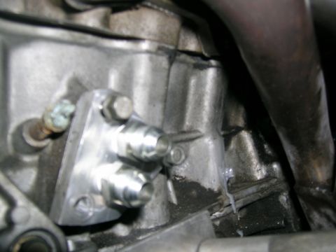 1995 Ford Probe - An aftermarket oil cooler adapter is installed on the engine block, multiple ports for oil lines.