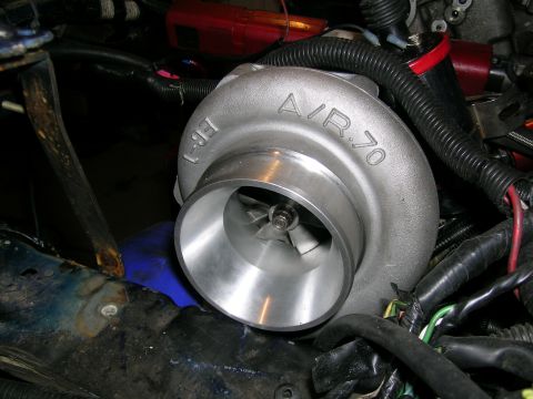 1995 Ford Probe - Close-up of a turbocharger part, with visible markings and fan blades.