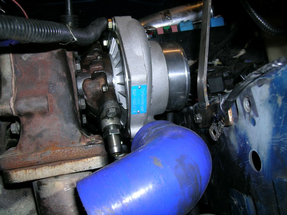 Turbocharger with blue hose and visible part number on blue tag