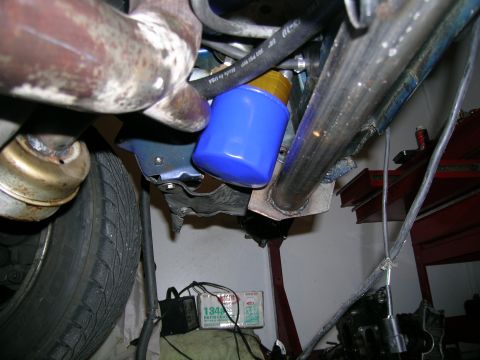 1995 Ford Probe - Underside view of a vehicle's engine bay, focusing on the oil filter and exhaust system.