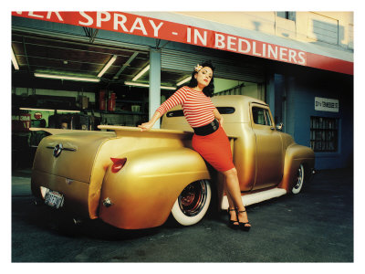 1991 Ford LTD Crown Victoria - A pin-up model poses with a customized gold pickup truck in front of a garage.