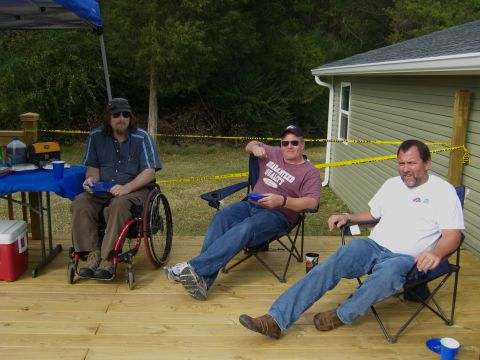 2007 Ford Mustang - Three men relax on a deck outside a house, with a cooler and drinks on a nearby table.