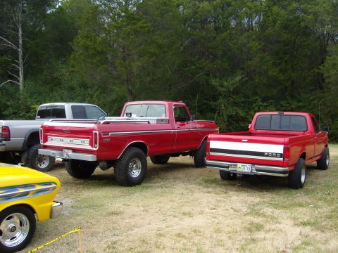 2007 Ford Mustang - A red Ford pickup truck is viewed from the rear, parked on grass with other vehicles nearby.