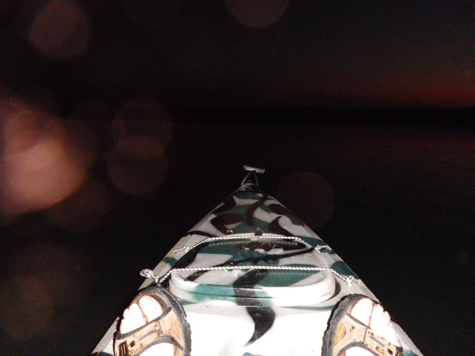 kayak with camouflage pattern, feet visible in foreground