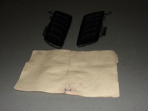 1996 Jeep Grand Cherokee - Two black vent covers and a paper template are laid out on a gray surface.