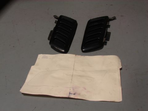 1996 Jeep Grand Cherokee - Two black vent covers and a paper template are laid out on a gray surface.