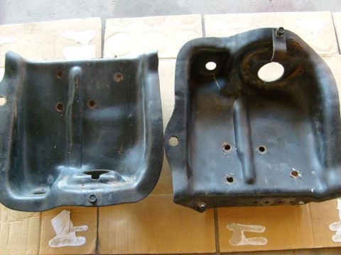 1986 Ford Bronco - Two metal brackets are shown side-by-side on a tiled surface.