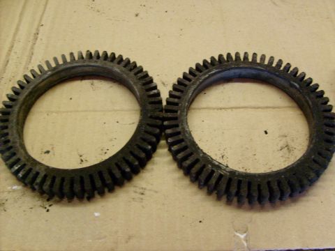 1986 Ford Bronco - Two gears are shown up close, resting on a textured surface.