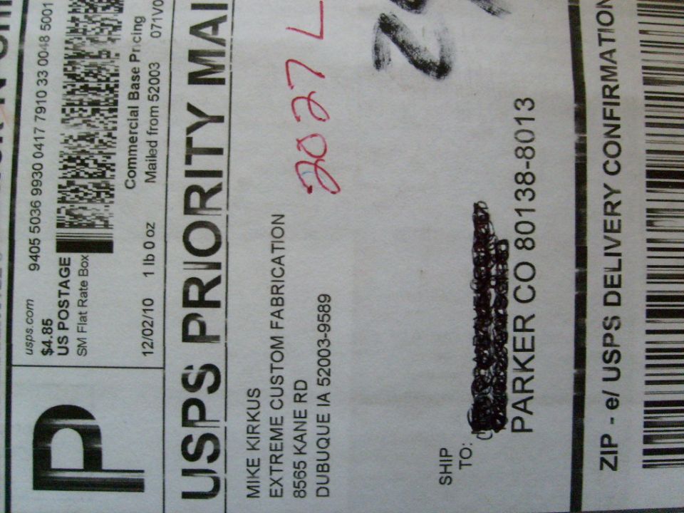 USPS Priority Mail label with handwritten date 02/02/10 and tracking number