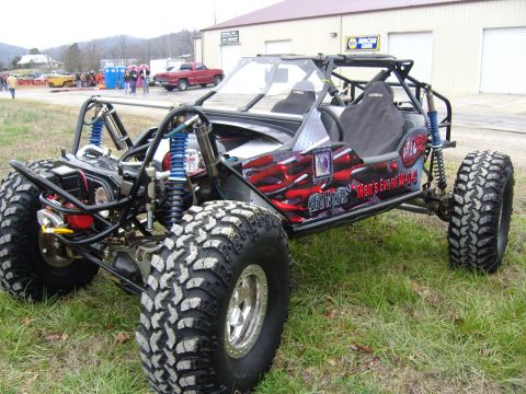 2007 Ford Mustang - A custom-built buggy with flame graphics and oversized tires sits on a grassy field.