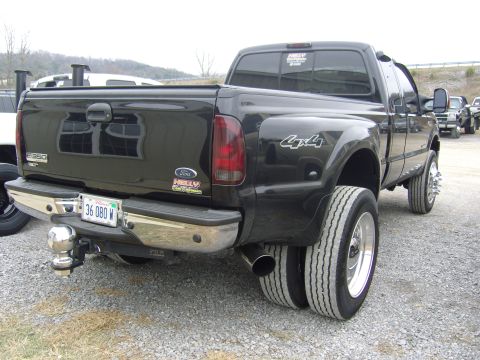 2007 Ford Mustang - Rear view of a black Ford F-350 Super Duty dually pickup truck, showing dual exhaust and 4x4 badging.