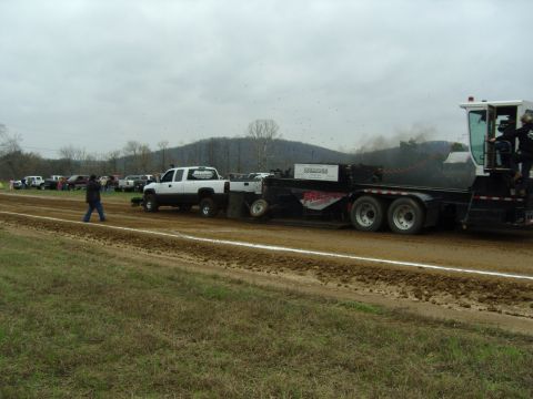 2007 Ford Mustang - Truck and sled competition on a cloudy day with spectators watching.