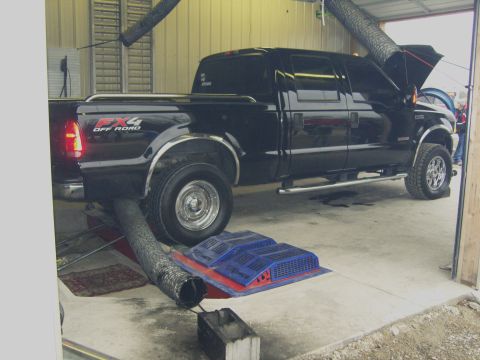 2007 Ford Mustang - A black Ford F-250 Super Duty pickup truck is positioned on a dynamometer for testing.