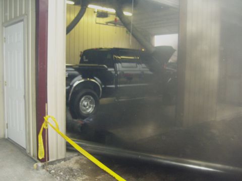 2007 Ford Mustang - Pickup truck with its hood open inside a garage bay, showing its side profile.