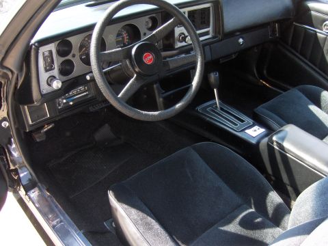 1979 Chevrolet Camaro - The interior of a 1979 Chevrolet Camaro shows black cloth seats and a dashboard with classic gauges.
