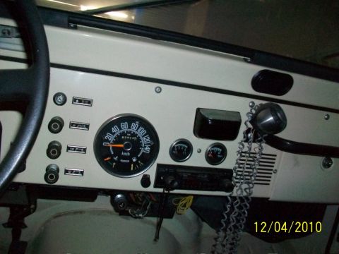 1986 Jeep Wagoneer - The interior dashboard of a 1986 Jeep Wagoneer, the speedometer, radio, and various controls.
