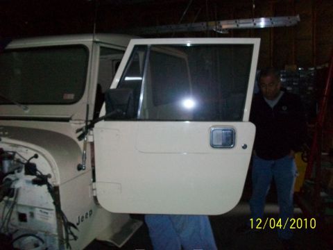 1986 Jeep Wagoneer - A cream-colored Jeep CJ-8 Scrambler is shown with its driver's side door open.