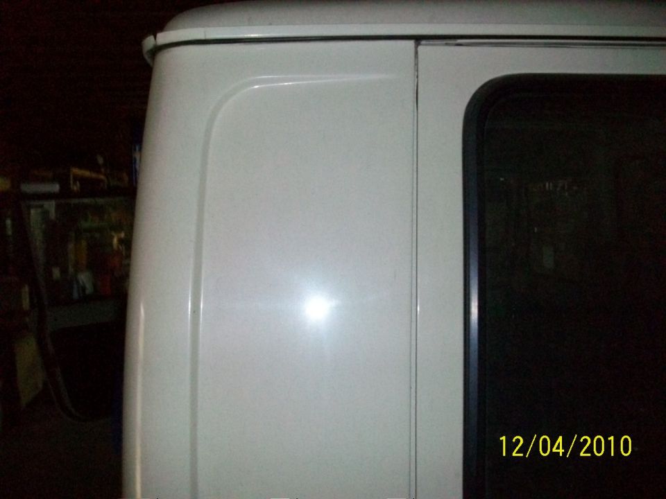 close-up of white van's rear side panel and window