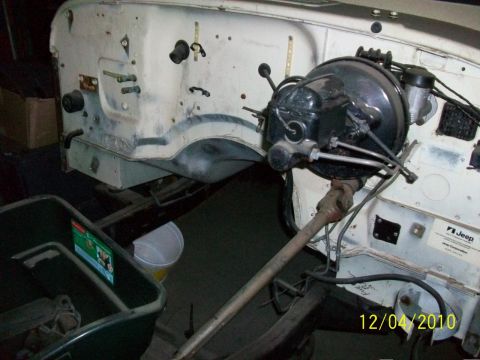 1986 Jeep Wagoneer - The engine bay of a Jeep shows the brake booster and steering column, with a date stamp of 12/04/2010.
