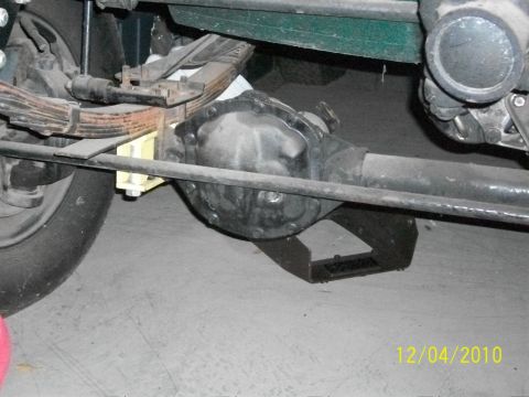 1986 Jeep Wagoneer - Close-up view of the rear axle and suspension system of a vehicle.