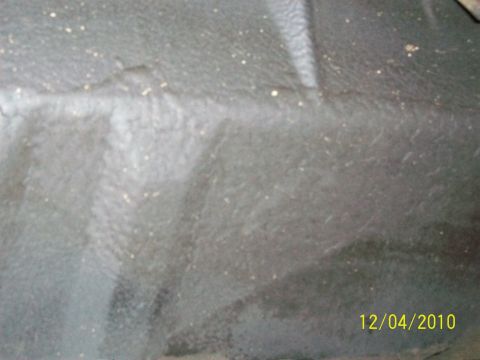 1986 Jeep Wagoneer - Close-up of a gray interior floor mat with visible dirt and a white accent stripe.