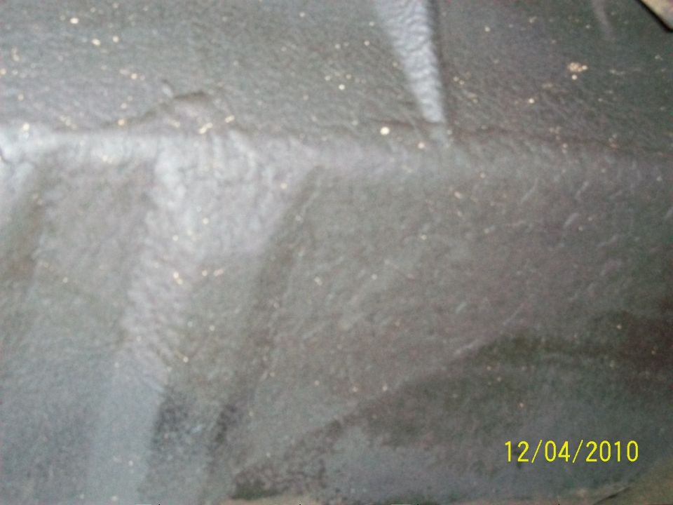 Gray interior floor mat with dirt specks and a white stripe