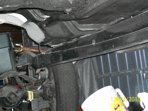 1986 Jeep Wagoneer - Underside view shows the frame, suspension components, and fuel tank of a vehicle.