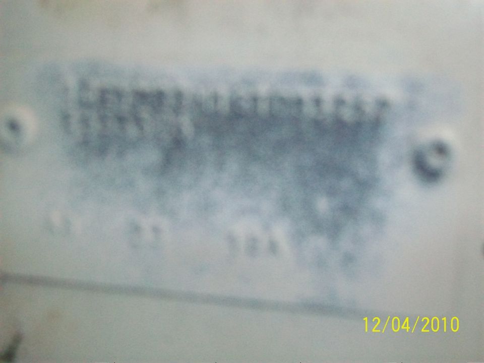 Close-up of a VIN plate with blurred text and numbers