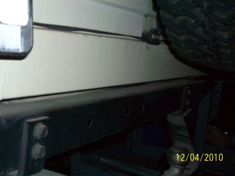 1986 Jeep Wagoneer - A close-up view of a Jeep's exterior, showing a portion of the body and bumper.
