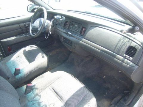 2003 Ford Crown Victoria - Interior view of a 2003 Ford Crown Victoria, showing the dashboard and front seating area.