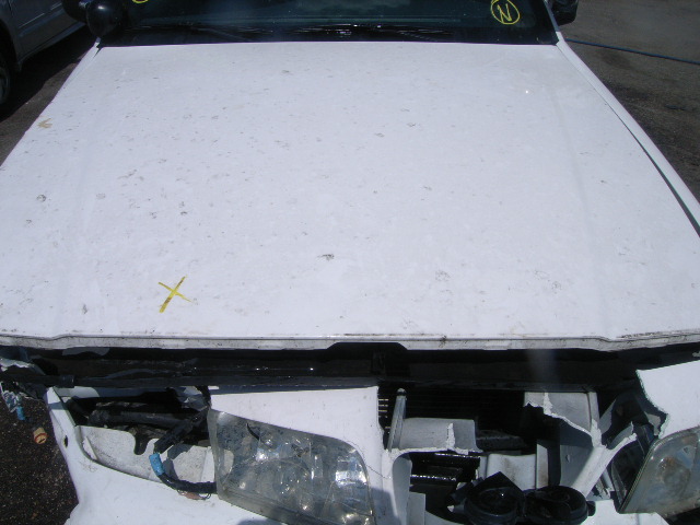 White car hood with yellow marks and damaged front end with exposed headlights