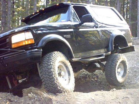 1995 Ford Bronco - This 1995 Ford Bronco is navigating a challenging off-road course with its suspension articulated.