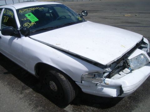 2003 Ford Crown Victoria - This vehicle has significant damage to its front end, including the bumper, grille, and headlights.