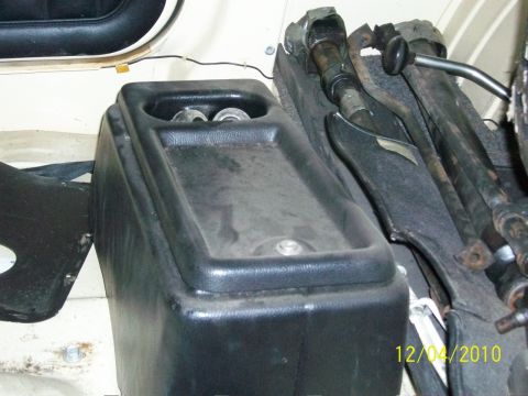 1986 Jeep Wagoneer - Close-up of a vehicle's interior showing the center console and floor shifter mechanism.