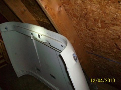 1986 Jeep Wagoneer - Car hood stored in attic space under wooden beams.