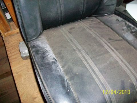 1986 Jeep Wagoneer - A close-up view of a worn black car seat, revealing its interior details and a timestamp from Supermotors.net.