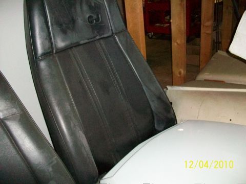 1986 Jeep Wagoneer - The interior of a Jeep shows black leather seats with a CJ logo visible on the headrest.