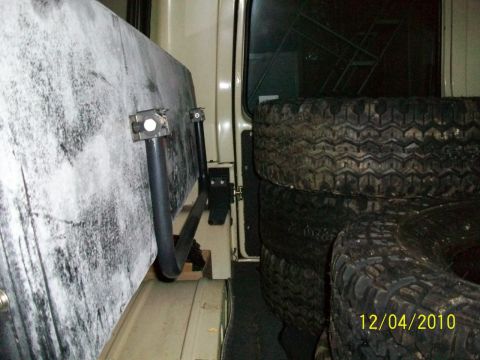 1986 Jeep Wagoneer - Stack of spare tires visible inside the cargo area of a vehicle.