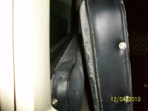 1986 Jeep Wagoneer - Close-up of the interior of a vehicle, focusing on the black seats and their condition.