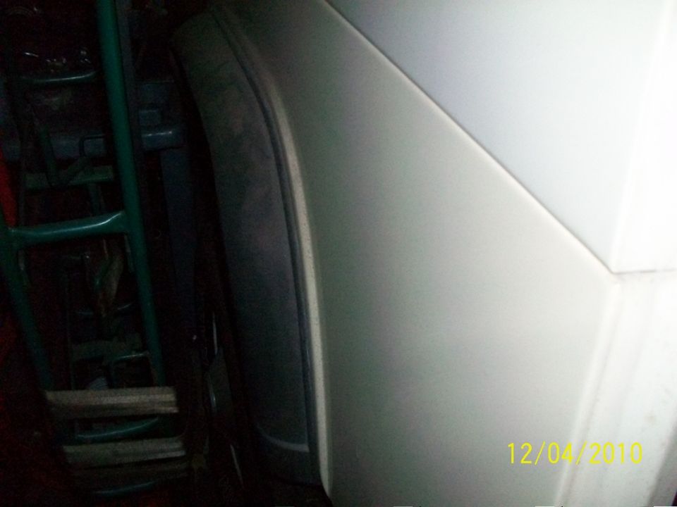 Silver vehicle body panel with a dark interior structure visible behind it